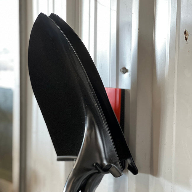Vibrant red 2.5-inch open hook securely holding a shovel, showcasing its durability and strength. This hook is perfect for organizing gardening tools, keeping your shed or garage neat and accessible. Its eye-catching color and sturdy build make it an excellent choice for functional and stylish storage solutions in outdoor or indoor environments.