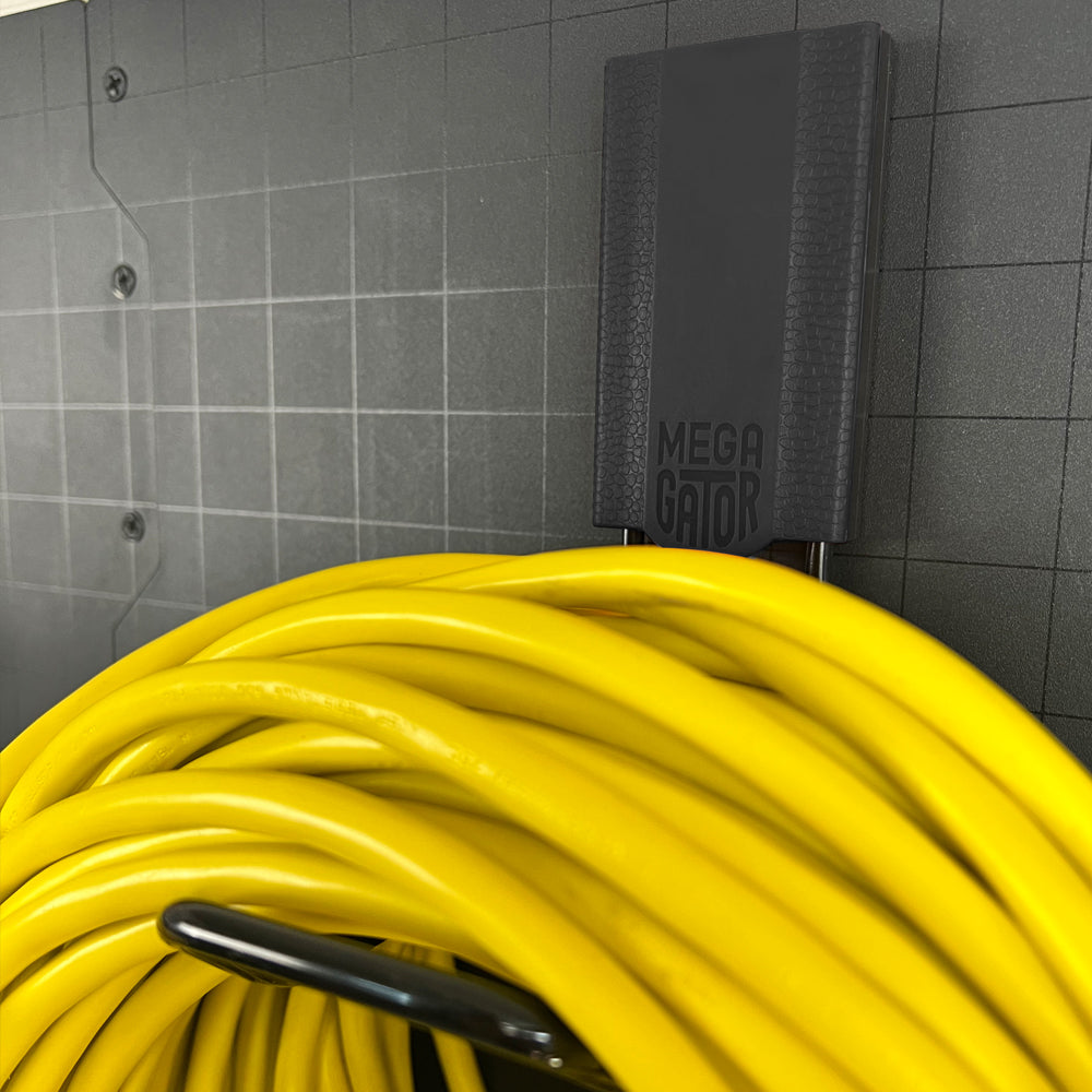 A close-up of a Mega hook holding a garden hose, showcasing the hook’s sturdy design and ability to handle heavy items. This image emphasizes the hook’s functionality and strength, making it perfect for organizing and storing various tools and equipment in your garden or workshop.