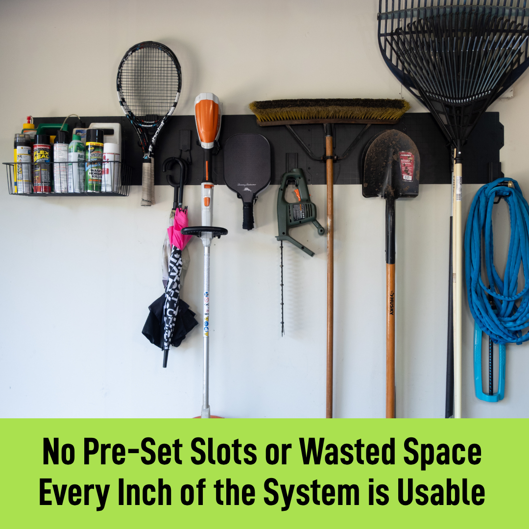 Black magnetic garage wall storage system holding rakes, sports gear, hoses and tools.