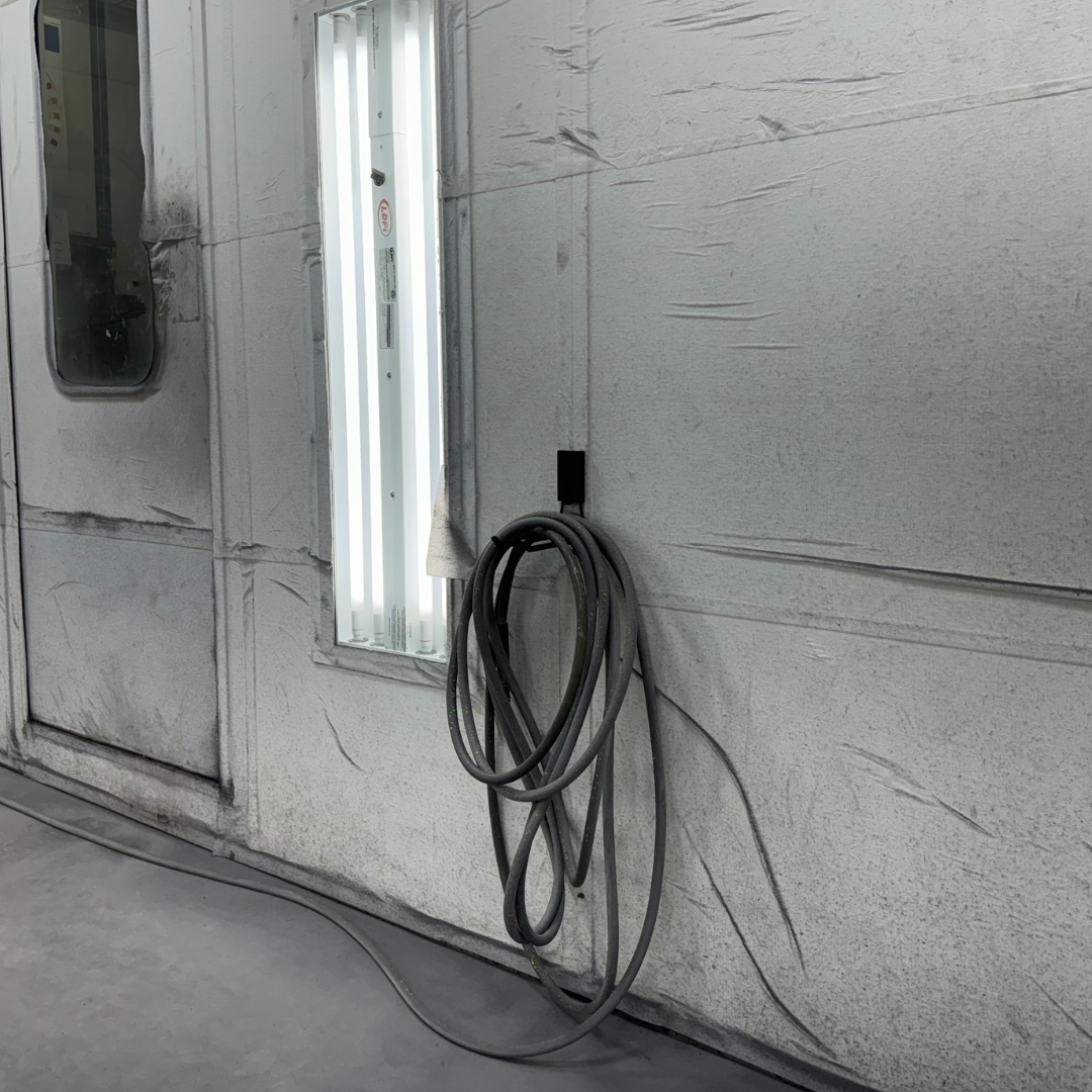 Gator Magnetics heavy duty magnetic hook in auto shop paint booth holding paint gun hose for organized paint equipment storage and workshop organization