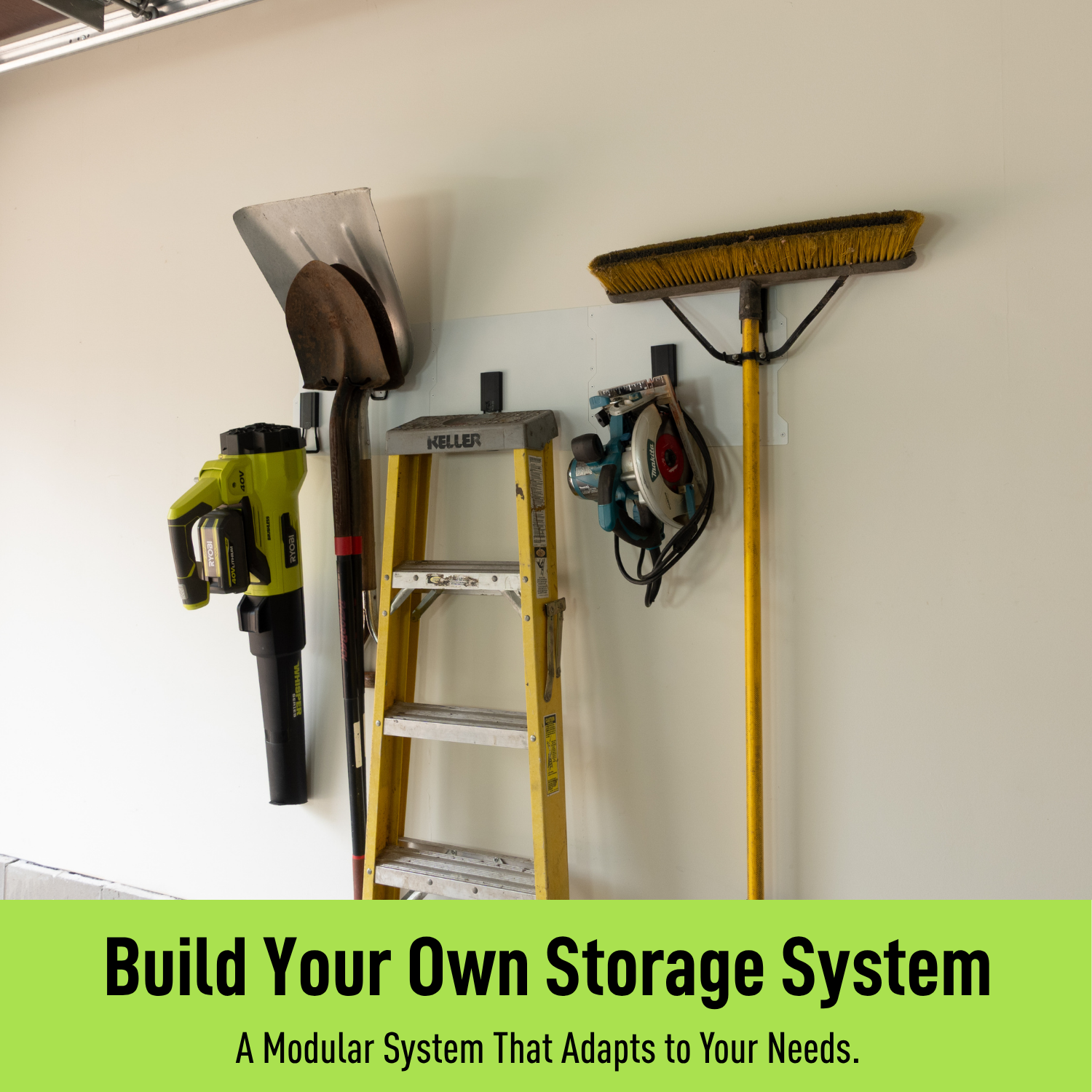 White 50-inch magnetic wall storage system organizing a ladder, shovel, broom and tools.