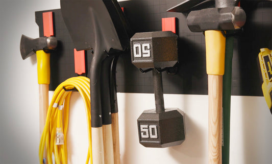 Magnetic storage hook holding heavy tools in garage
