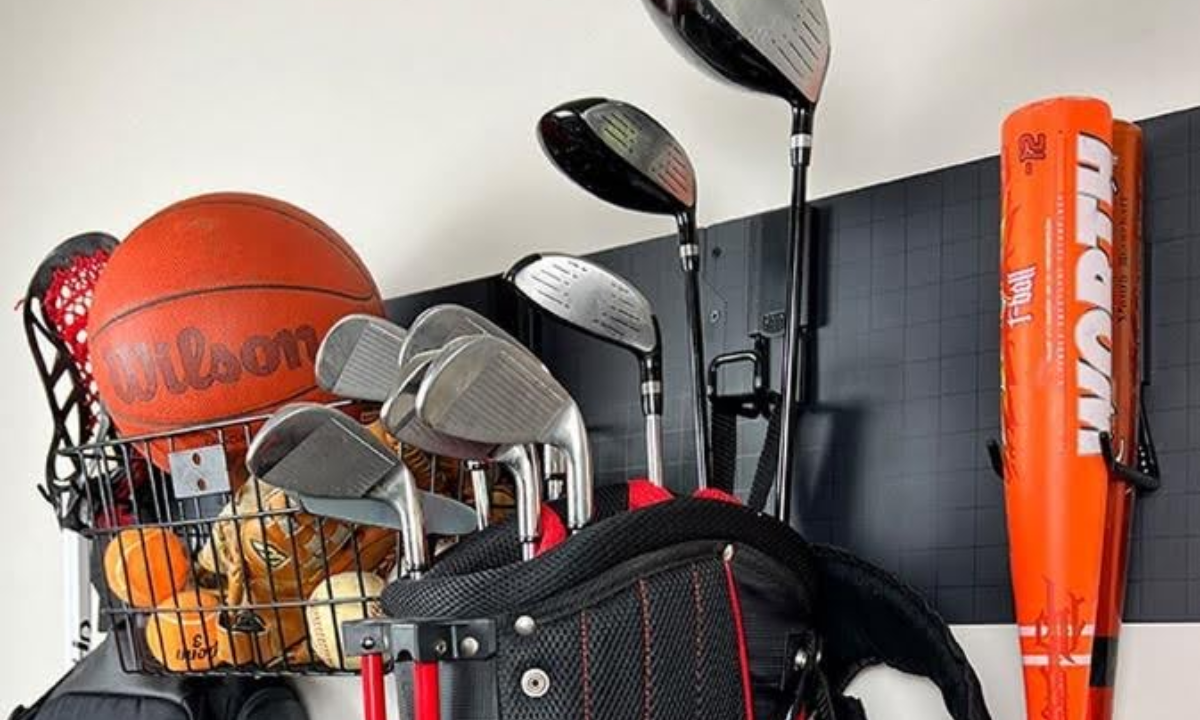 Gator magnetic basket on a steel wall panel holding a basketball, lacrosse stick, baseballs and ping pong balls.