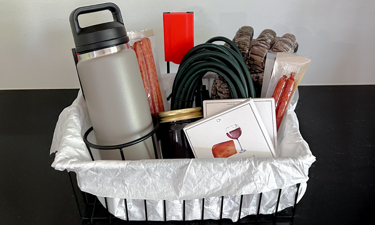Father’s Day gift basket with insulated tumbler, snacks, gloves and accessories.