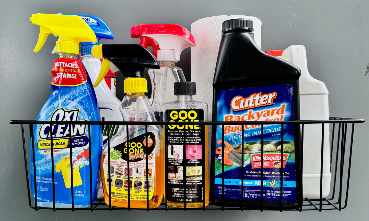 Black Gator magnetic basket on a gray steel wall holding household cleaning sprays.