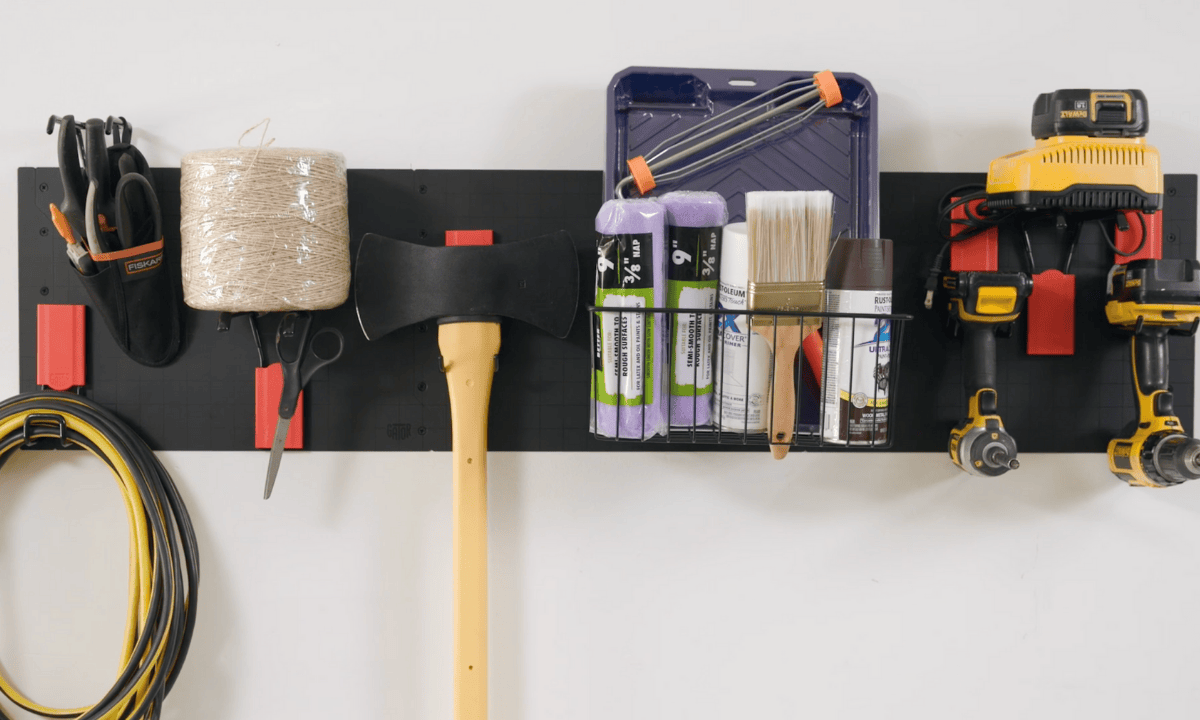 Gator Steel Wall Panel with magnetic hooks and baskets organizing cleaning supplies and power tools.