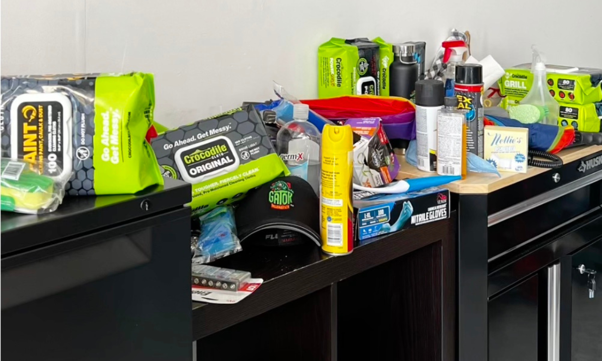 Painting and cleaning supplies including cloths, spray bottles, gloves and aerosol cans.