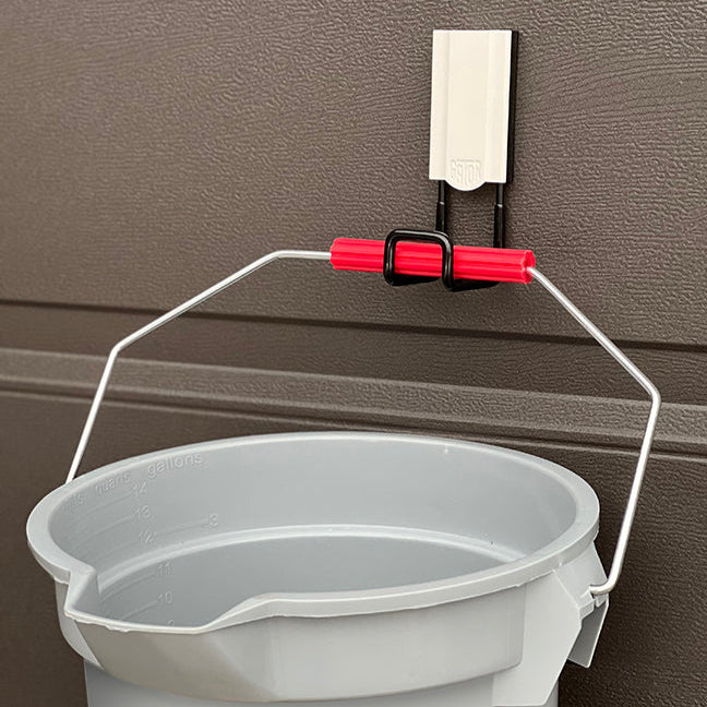 White 2.5" closed magnetic hook supporting a bucket with a 25 lbs capacity. Ideal for organizing buckets, tools, and other essentials in garages, workshops, and industrial settings. Provides a secure and reliable magnetic hold on steel surfaces for efficient workspace management.
