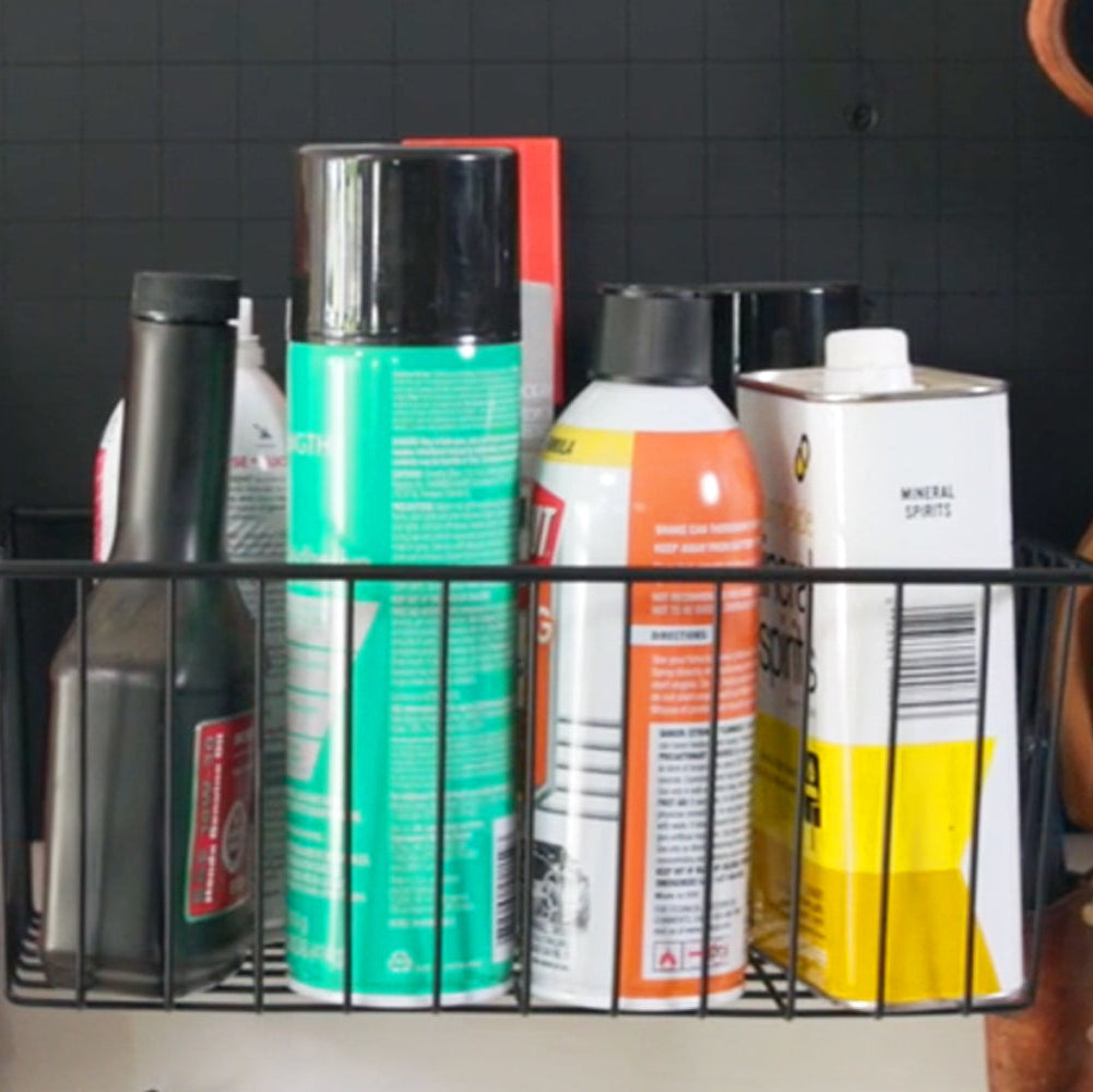 The small magnetic utility basket is shown holding mineral spirits, oil, and various garage supplies. This compact yet sturdy basket is designed for organizing essential items in your workspace, ensuring everything is easily accessible. Its secure magnetic hold attaches to steel surfaces, making it an ideal choice for keeping garage tools and supplies neatly organized. The practical design enhances efficiency, making it a valuable addition to any workshop or garage setup.