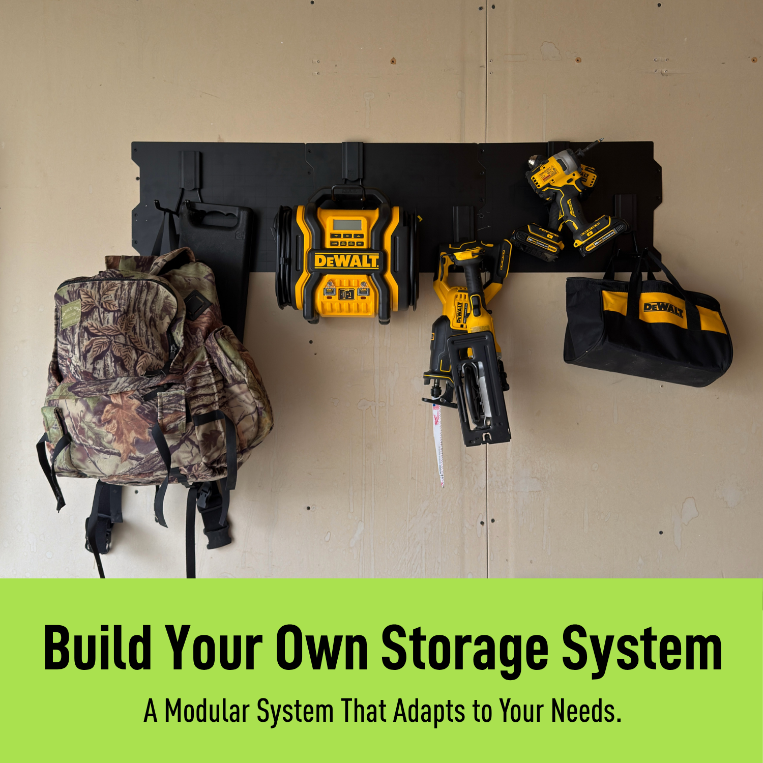 Black 50-inch magnetic wall storage system holding a backpack, drills, broom and yard tools.