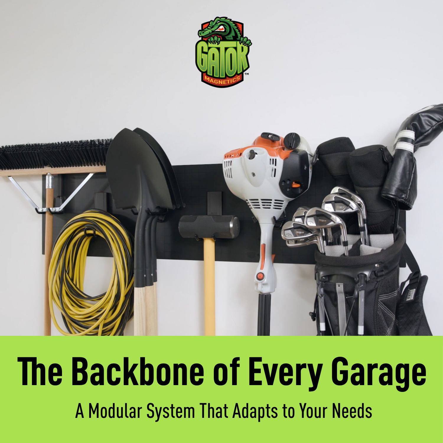 Black magnetic garage wall storage system holding yard tools, golf bags, hoses and power tools.