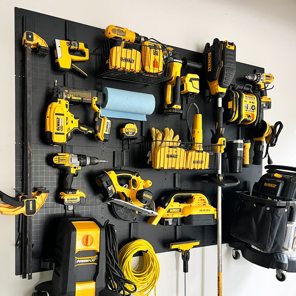 DEWALT power tools, gloves, clamps and extension cords organized on a Gator Steel Wall Panel.
