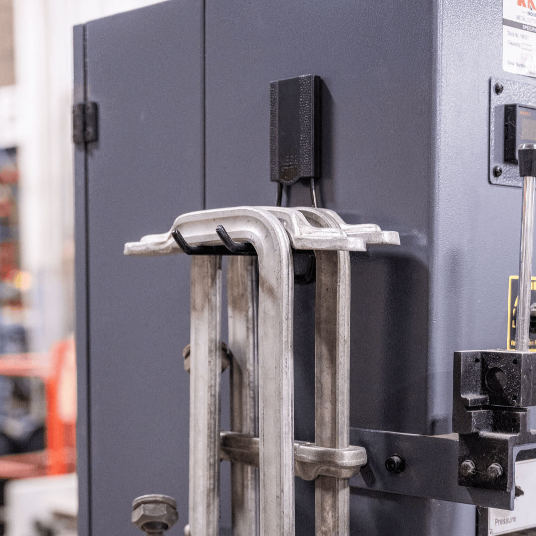 Gator magnetic hook on a steel cabinet door holding four large clamps.