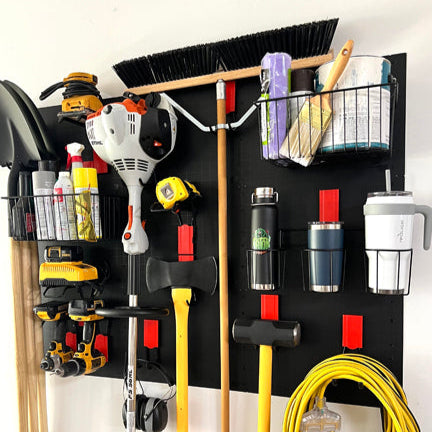 Red Gator Magnetics magnetic hooks and black baskets organize tools, cords and drink containers on a black steel wall panel.