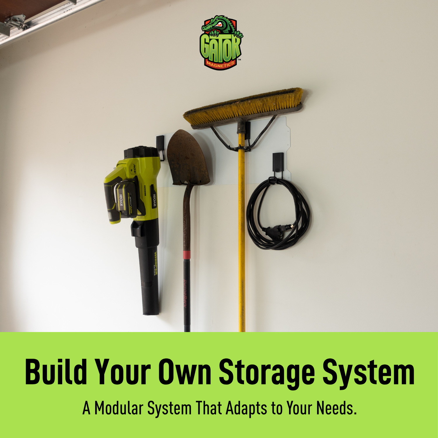 White 34-inch magnetic wall storage system organizing a broom, drill, shovel and cord.